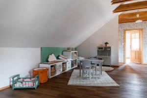 a childs room with a table and a refrigerator at Domeček v Chaloupkách in Zdice