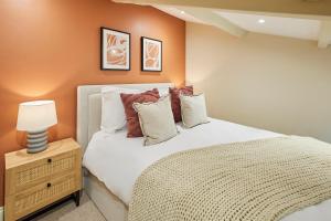 a bedroom with a bed and a lamp on a night stand at Host & Stay - Cinnamon Cottage in Barnard Castle