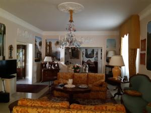a living room with a couch and a chandelier at Villa Manuela in Altopascio