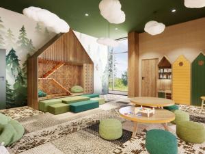 a room with a fireplace and a table and chairs at Mercure Szczyrk Resort in Szczyrk