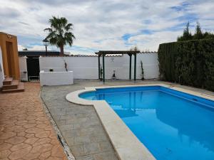 a swimming pool in a yard with a fence at Stunning 3-Bed Villa detached with private pool in Zurgena