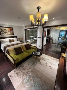 a bedroom with a large bed and a chandelier at JB Serviced Apartment in Hanoi