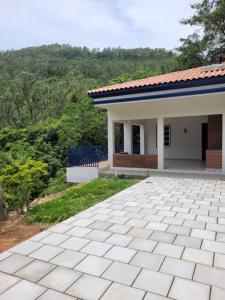 a small house with a tiled driveway in front of it at Fazenda São Miguel in Monte Alegre do Sul
