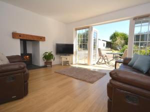 a living room with a couch and a fireplace at 2 Bed in Cosheston 60704 in Cosheston