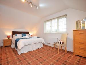 a bedroom with a bed and a dresser and window at 2 Bed in Cosheston 60704 in Cosheston