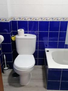 un bagno blu e bianco con servizi igienici e vasca di Ampuero, Cantabria, RÍO ASÓN. Hasta 6 personas ad Ampuero