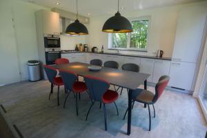 a kitchen with a table and chairs in a room at Razende Bol in De Koog