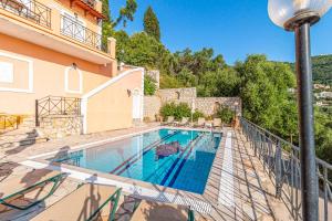 a villa with a swimming pool and a house at Villa Agni Sea View in Agní