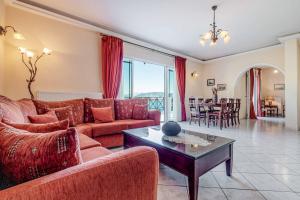 a living room with a couch and a table at Villa Agni Sea View in Agní
