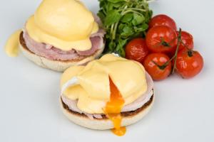 two sandwiches with cheese and tomatoes on a white plate at Darwin's Townhouse in Shrewsbury