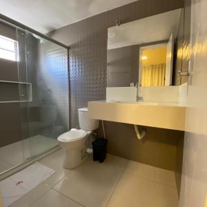a bathroom with a toilet and a sink and a shower at Onix Hotel Praia de Piata in Salvador