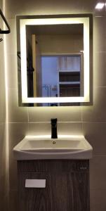 a bathroom with a sink and a mirror at Lake Hill Resort Kanchanaburi in Tha Kradan