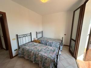 a bedroom with two beds and a window at Appartamento La Casa Di Simo in Montecalvoli