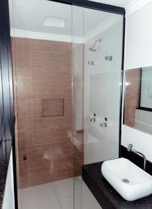 a bathroom with a shower with a toilet and a sink at Bob Motel in Sao Paulo
