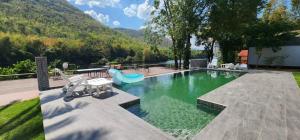 a swimming pool with a view of a mountain at Lake Hill Resort Kanchanaburi in Tha Kradan