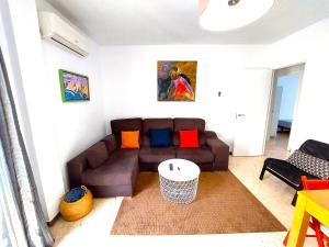 a living room with a couch and a table at Enladrillada Apartment in Seville