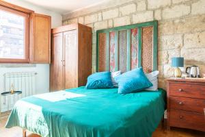 a bedroom with a bed with blue pillows at Bari LandLord 71 - Central Rooms in Bari