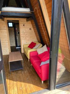 a room with a couch and a table in a cabin at B&B Belvedere in Presa