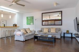 a living room with two couches and a coffee table at Villa Marisol, Los Mojones in Tías