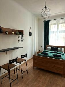a bedroom with a bed and a table and chairs at Wielopole Classy Rooms in Krakow
