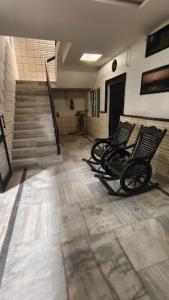 a row of chairs sitting in a room with stairs at Hotel Kamal Agra in Agra