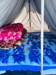 a bed in a tent with two pillows on it at Kedarnath Tent Prithvi yatra Hotel in Kedārnāth