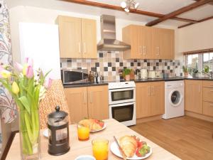 a kitchen with a table with plates of food on it at 1 bed in Brampton 56564 in Irthington