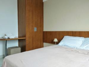 Ένα ή περισσότερα κρεβάτια σε δωμάτιο στο Terra Hospedagem flats aconchegantes piscina e academia via park +32 φωτογραφίες