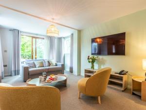 a living room with a couch and a table at 2 Bed in St. Mellion 87707 in St Mellion