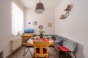 a living room with a table and a couch at Brīvdienu māja pašā Rīgas sirdī in Riga