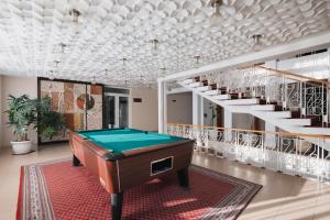 a pool table in a room with a staircase at Balneocomplex Kamena in Velingrad