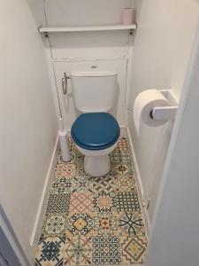 uma casa de banho com WC e assento azul em Studio port et mer em Le Grau-du-Roi