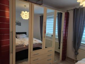 a bedroom with a large wooden cabinet with mirrors at Private Rooms in Hannover