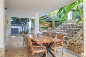 a dining room with a wooden table and chairs at Villa Jazmin in Mijas Costa
