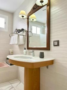 a bathroom with a sink and a mirror at Apartamento Alteagroup Centro in Altea
