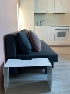a couch with pillows and a table in a living room at Appartamento Nido Vista Lago in Padenghe sul Garda
