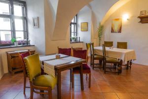 a restaurant with tables and chairs in a room at Penzion St. Martin in Spišské Podhradie