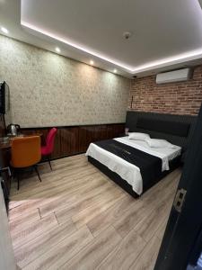 a bedroom with a bed and a desk and a chair at Dolce Vita Suite Hotel in Istanbul