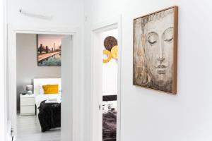 a room with art on the walls and a bed at Skyline Sunset View -XCity Tower - By OpenHouse apartments in Timişoara