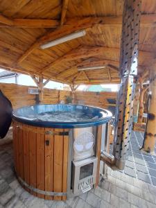 a hot tub in a room with a wooden ceiling at AB Musiol in Świnoujście