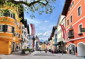 a city street with buildings and people walking on the street at BELLE KITZ im Zentrum by Belle Stay in Kitzbühel
