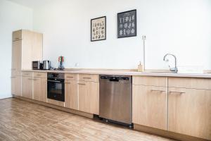 a kitchen with wooden cabinets and stainless steel appliances at B23 Monteure I Einzelbetten I 5-Zimmer I TV I Bad NEU I Premiumbettwäsche in Ibbenbüren