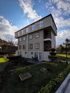 a large building with a yard in front of it at Istanbul Park Hotel in Tuzla