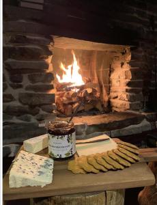 a fireplace with a batch of cookies and a jar of jam at Villa Poronperä in Kuusamo