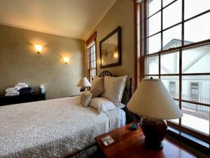 a bedroom with a bed and a large window at Bella Vita Estate Luxury Home With Hot Tub on Golf Course in Baker City