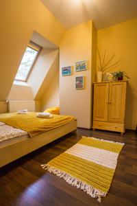 a bedroom with a bed and a window and a rug at Koślówka in Biały Dunajec