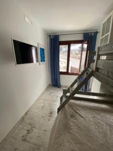 a room with a bed and a tv and a window at B&B Premium in Premia de Dalt