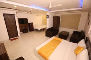 a bedroom with a bed and a living room at Hotel Kelvish Plaza-Near IGI Airport Terminal-3 in New Delhi