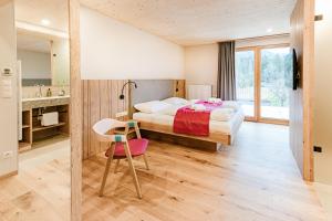 a bedroom with a bed and a desk and a chair at Ferienhof Reiterhof Edtbauer in Weyer Markt