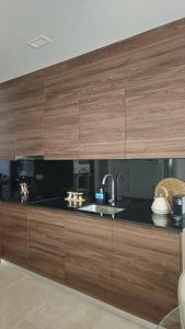 a kitchen with wooden cabinets and a sink at Imperial Apartamentos Valencia in Valencia